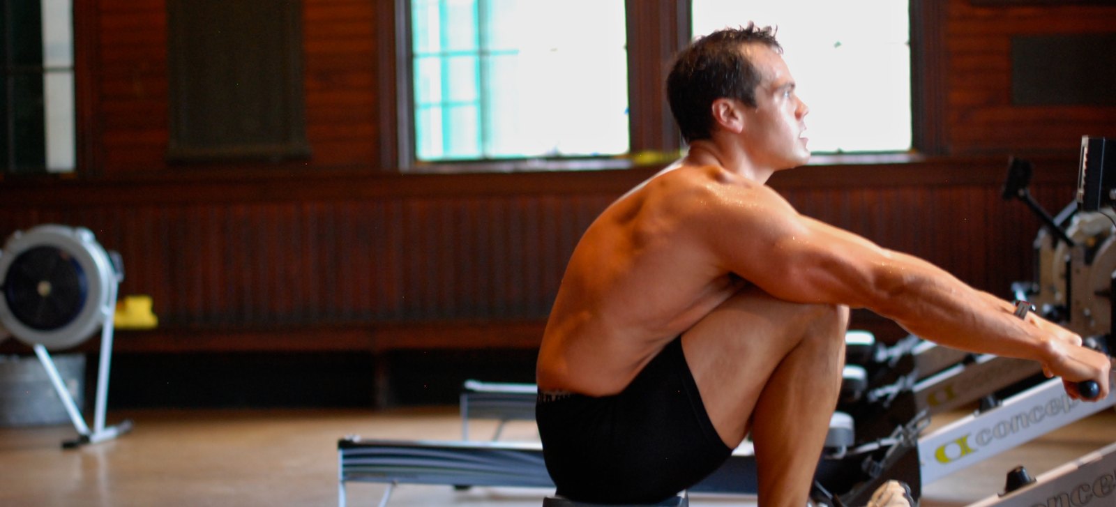 Daniel Marquardt at the catch on a Concept2 ergometer in a boathouse erg room
