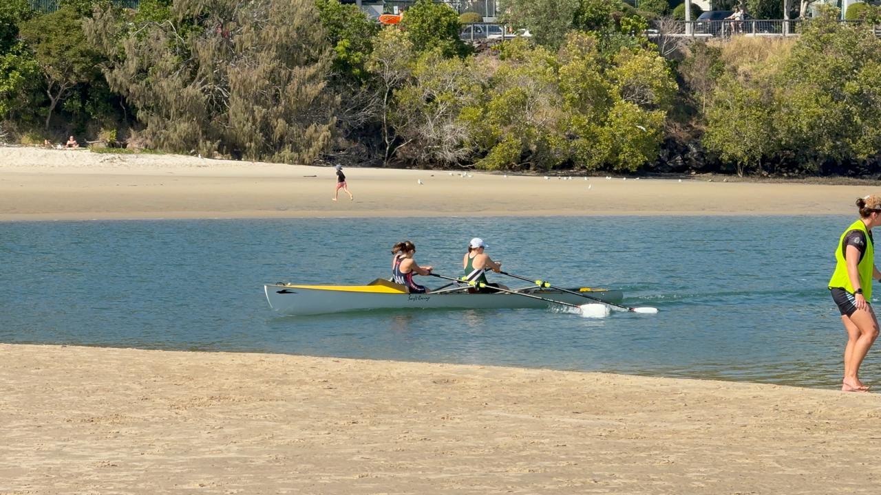 The Samoa and Gippsland Grammar double rowing in to the beach at Currumbin Creek during the Women's U19 Double