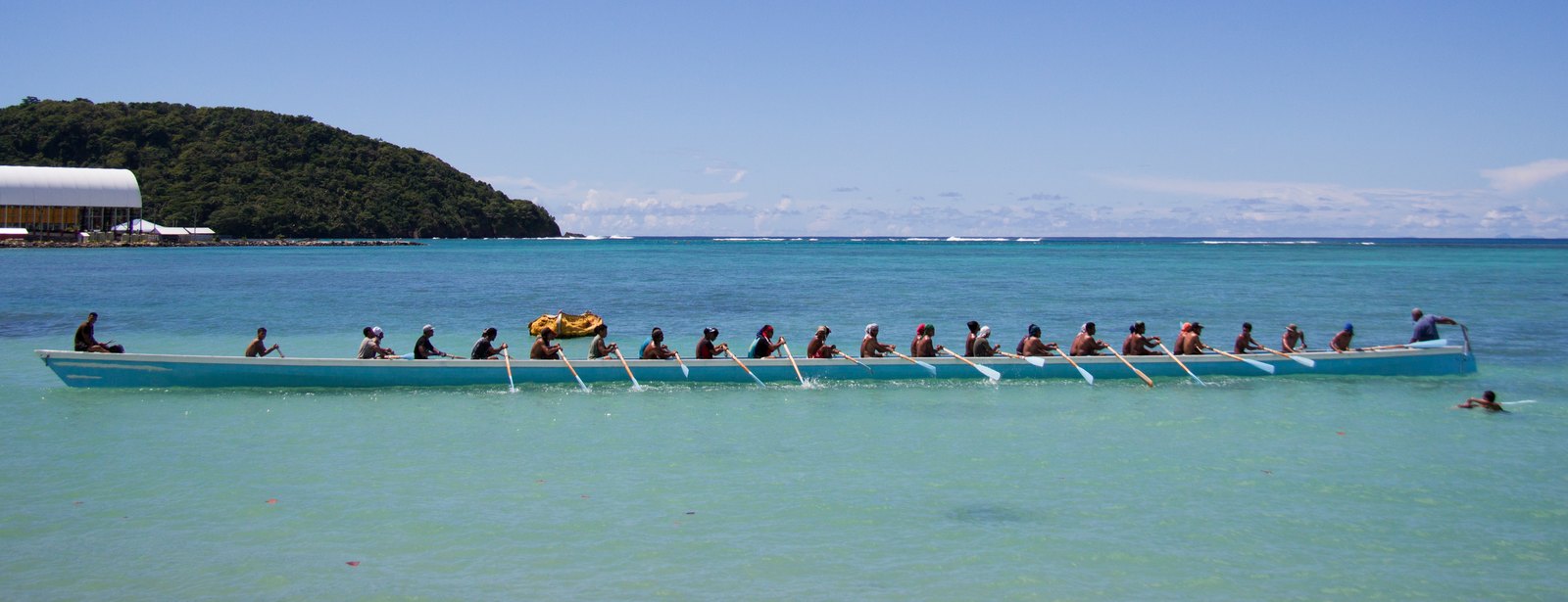 A full fautasi crew training on turquoise water off Upolu, Samoa